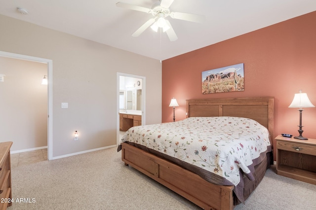 bedroom with light carpet, ensuite bath, and ceiling fan