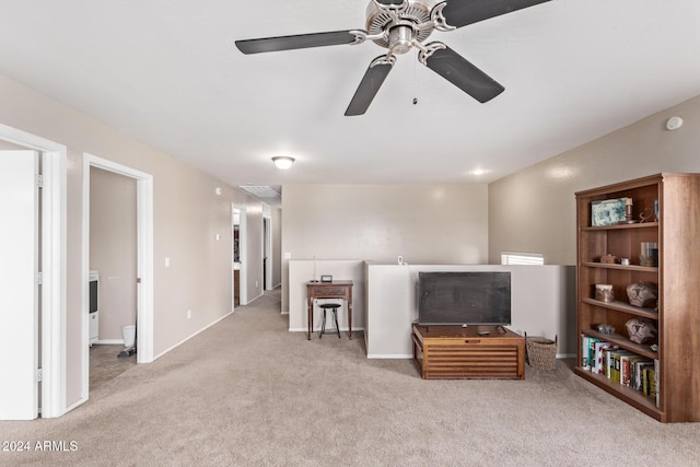 carpeted living room featuring ceiling fan