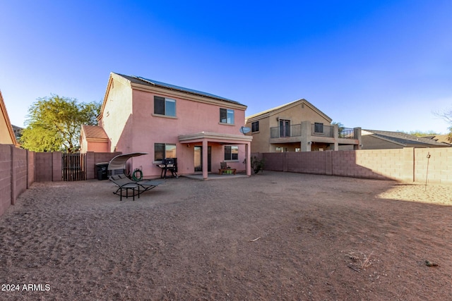 back of property with a patio