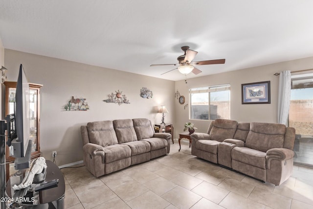 living room with ceiling fan and light tile patterned flooring