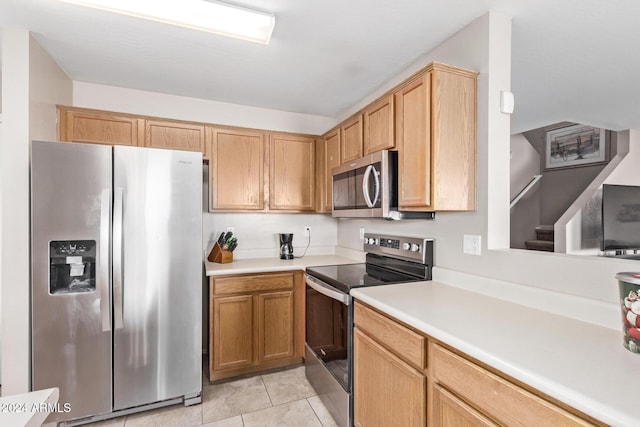 kitchen featuring light tile patterned floors and stainless steel appliances