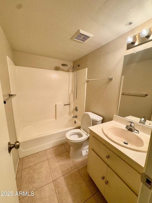 full bathroom featuring toilet,  shower combination, a textured ceiling, vanity, and tile patterned flooring