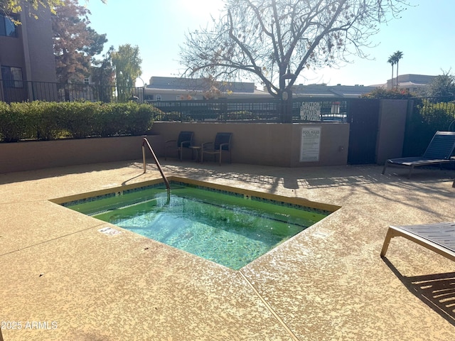 view of swimming pool with a hot tub and a patio