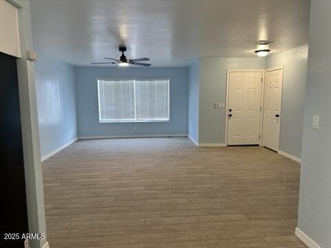 unfurnished living room with ceiling fan and light hardwood / wood-style floors