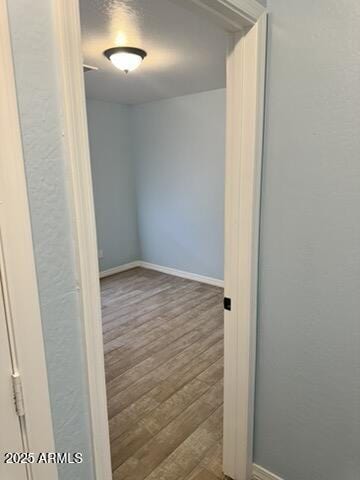 corridor with dark hardwood / wood-style flooring