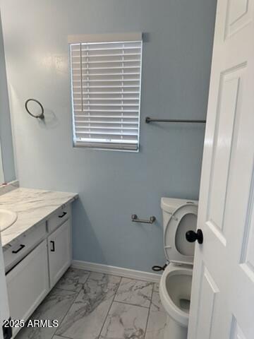 bathroom featuring vanity and toilet