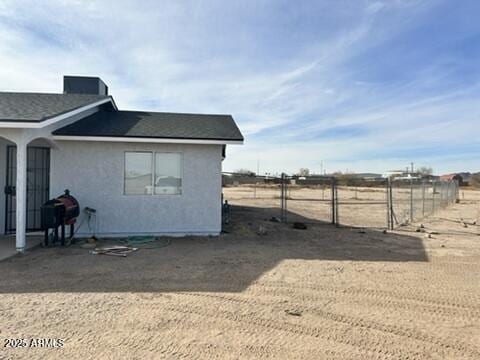 view of side of home featuring a rural view