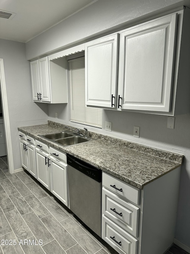 kitchen with dishwasher, sink, and white cabinets