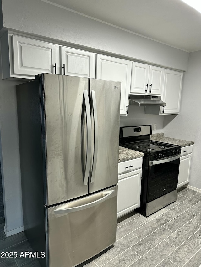 kitchen with appliances with stainless steel finishes, dark stone countertops, and white cabinets