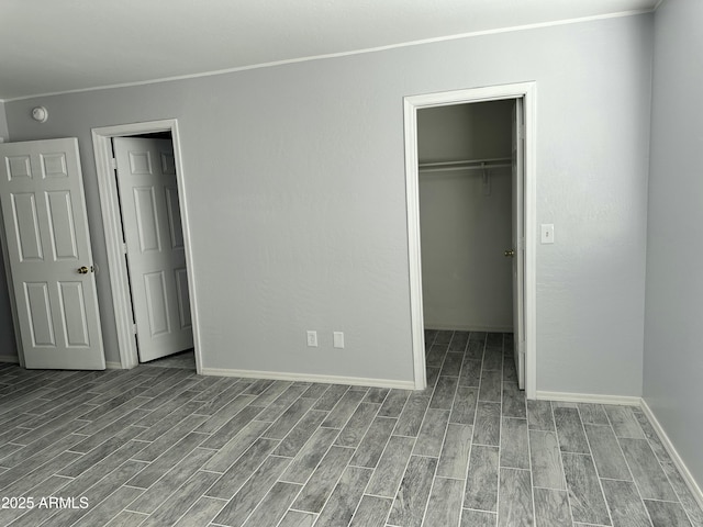 unfurnished bedroom with a walk in closet and a closet