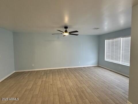 unfurnished room with ceiling fan and light wood-type flooring