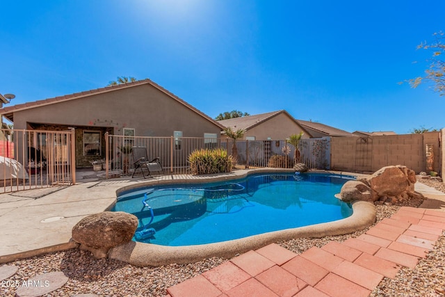 view of swimming pool with a patio area, fence, and a fenced in pool