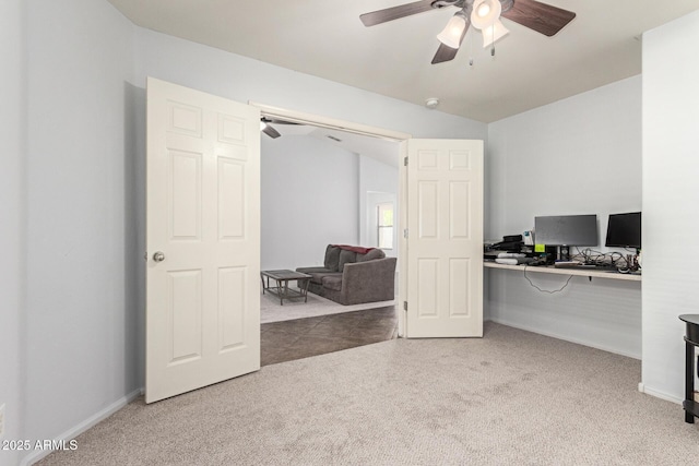 carpeted office featuring a ceiling fan and baseboards