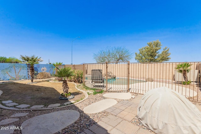 view of patio with a fenced backyard and a grill