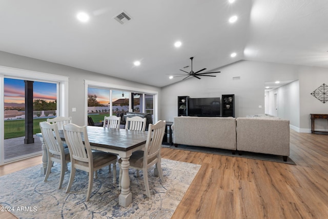 dining space with lofted ceiling, light wood-type flooring, and ceiling fan