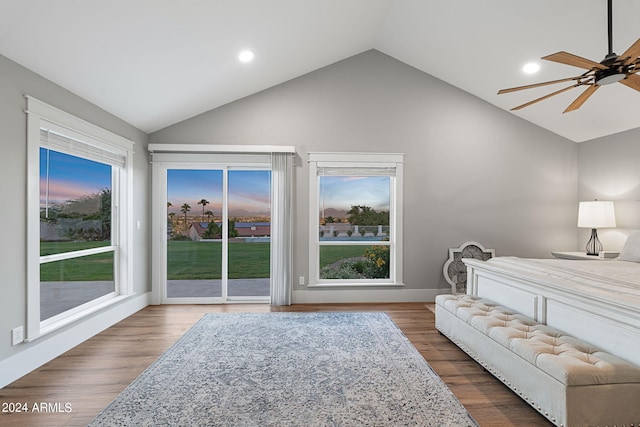 bedroom with access to exterior, multiple windows, ceiling fan, and lofted ceiling