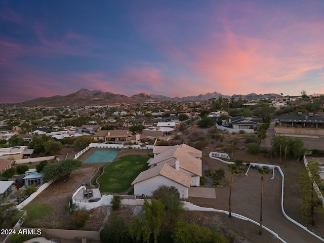 aerial view at dusk featuring a mountain view