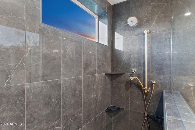 bathroom with a tile shower