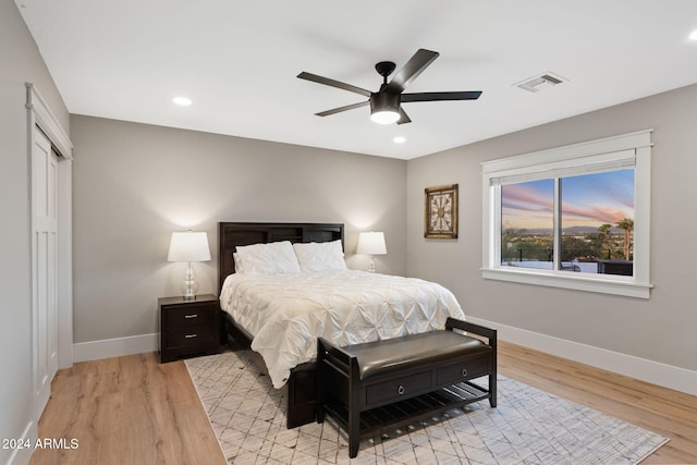 bedroom with ceiling fan and light hardwood / wood-style floors