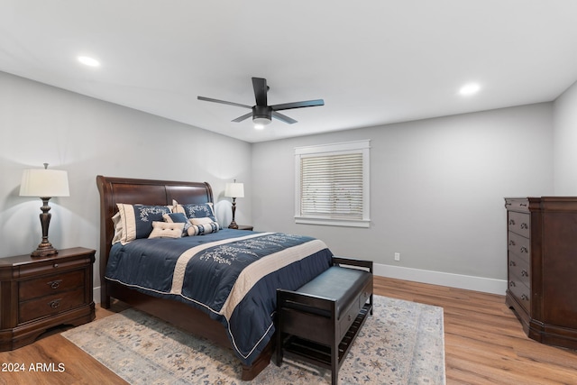 bedroom with light hardwood / wood-style flooring and ceiling fan