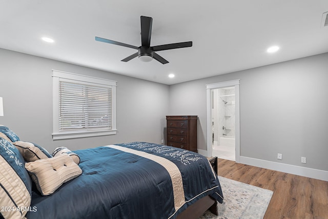 bedroom with ceiling fan, ensuite bath, and hardwood / wood-style floors