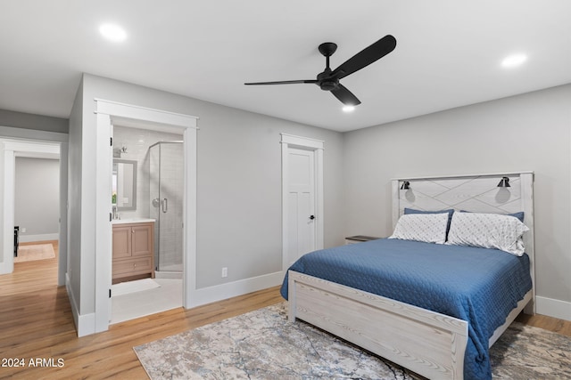 bedroom with ceiling fan, hardwood / wood-style floors, and ensuite bath