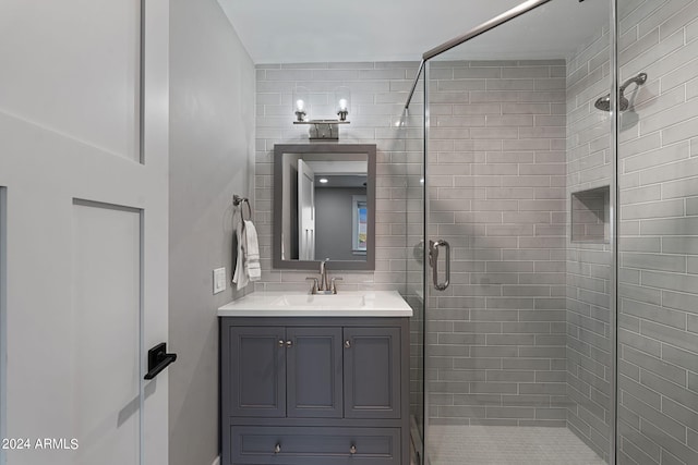 bathroom featuring walk in shower and vanity