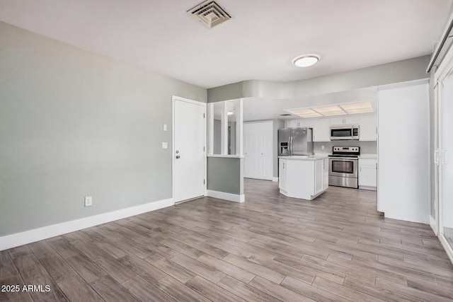 17201 N 35th Dr, Glendale, AZ 85308 - unfurnished living room featuring light wood-type flooring and baseboards