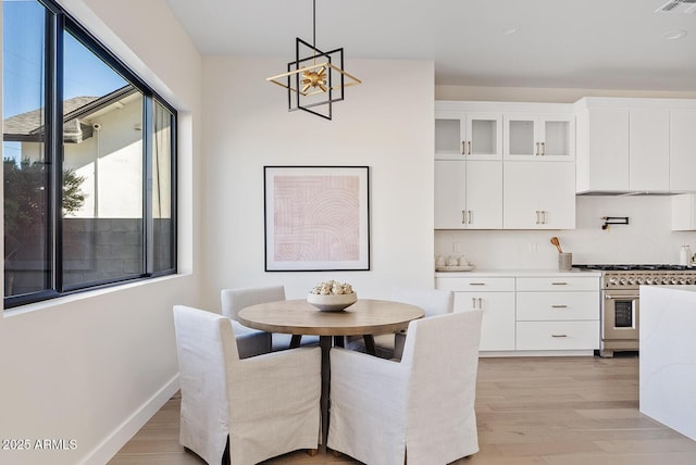 dining area featuring a chandelier and light hardwood / wood-style floors