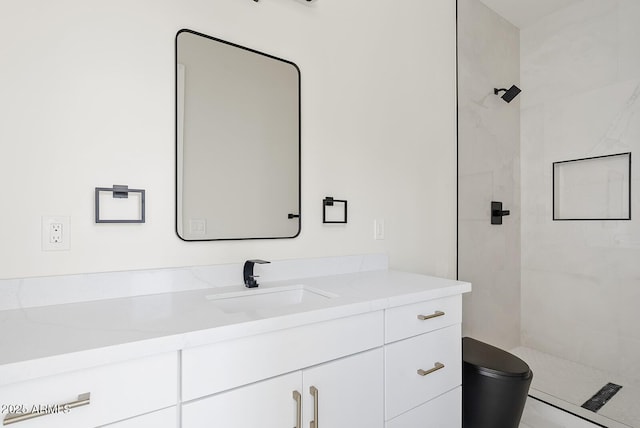 bathroom with vanity and a tile shower