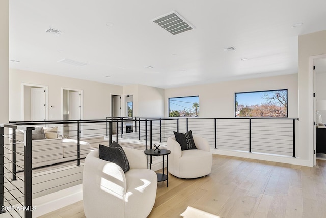 living area with light hardwood / wood-style flooring