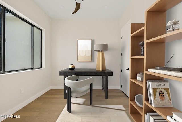 office area with light hardwood / wood-style flooring and ceiling fan