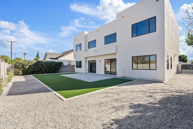 rear view of house with cooling unit, a yard, and a patio