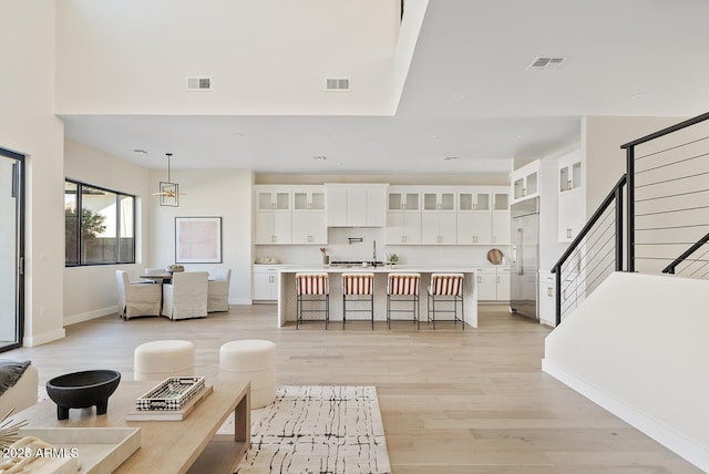 living room with an inviting chandelier and light hardwood / wood-style flooring