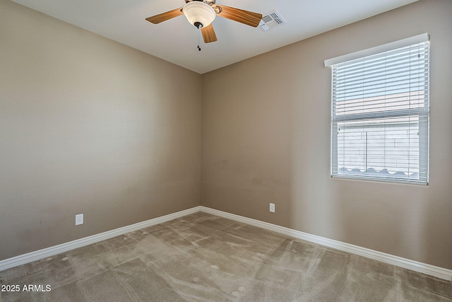 empty room with baseboards, visible vents, and carpet flooring