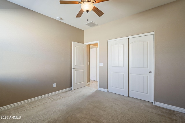 unfurnished bedroom featuring ceiling fan, carpet flooring, visible vents, baseboards, and a closet