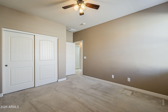 unfurnished bedroom featuring ceiling fan, carpet floors, visible vents, baseboards, and a closet