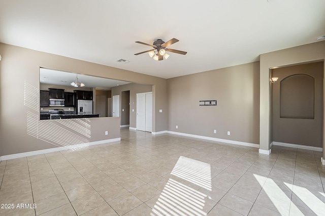 unfurnished living room with a ceiling fan, visible vents, baseboards, and light tile patterned floors