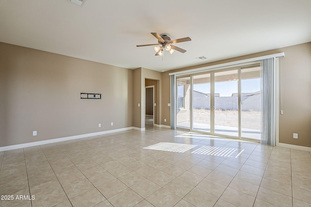 spare room featuring ceiling fan, visible vents, baseboards, and light tile patterned flooring