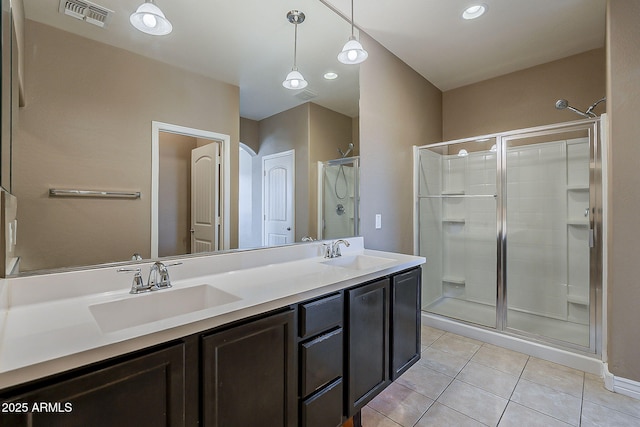 full bathroom featuring a shower stall, visible vents, a sink, and tile patterned floors