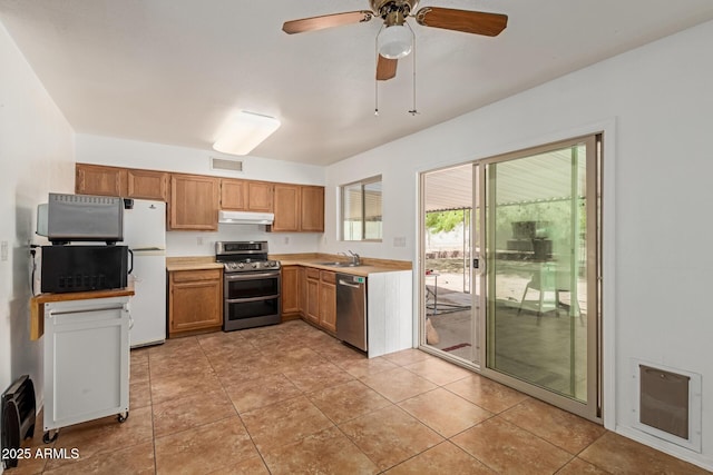 kitchen with visible vents, a sink, light countertops, under cabinet range hood, and stainless steel appliances