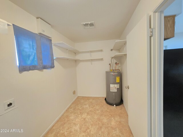 laundry area featuring cabinets and light colored carpet