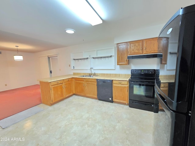 kitchen with black appliances, pendant lighting, kitchen peninsula, and sink