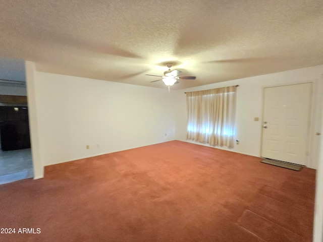 carpeted spare room with ceiling fan and a textured ceiling