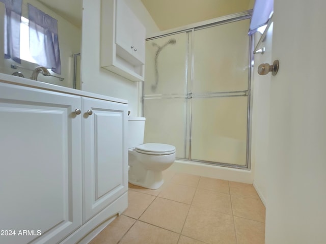 bathroom featuring tile patterned flooring, toilet, and walk in shower