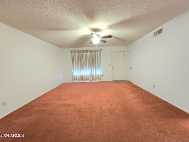 empty room with ceiling fan, carpet floors, and a textured ceiling