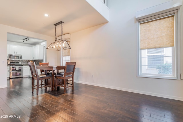 706 E Washington St Unit 124, Phoenix, AZ 85034 - dining room featuring baseboards and dark wood-style flooring