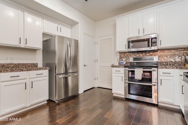 706 E Washington St Unit 124, Phoenix, AZ 85034 - kitchen with appliances with stainless steel finishes, white cabinets, tasteful backsplash, dark wood finished floors, and dark stone counters