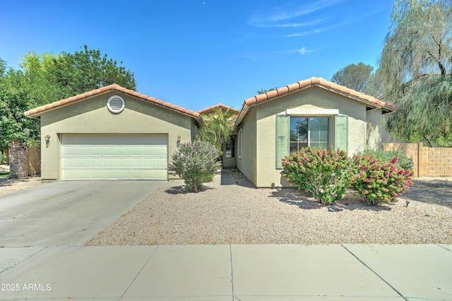 7815 S 22nd Ln, Phoenix, AZ 85041 - mediterranean / spanish home with stucco siding, a garage, driveway, and a tile roof
