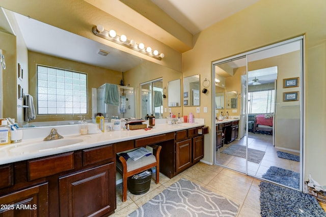 7815 S 22nd Ln, Phoenix, AZ 85041 - ensuite bathroom featuring a stall shower, double vanity, ceiling fan, a bath, and tile patterned floors